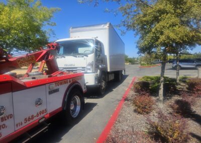 Heavy duty tow truck pulls box truck