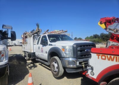 Heavy duty tow truck pulls utility truck